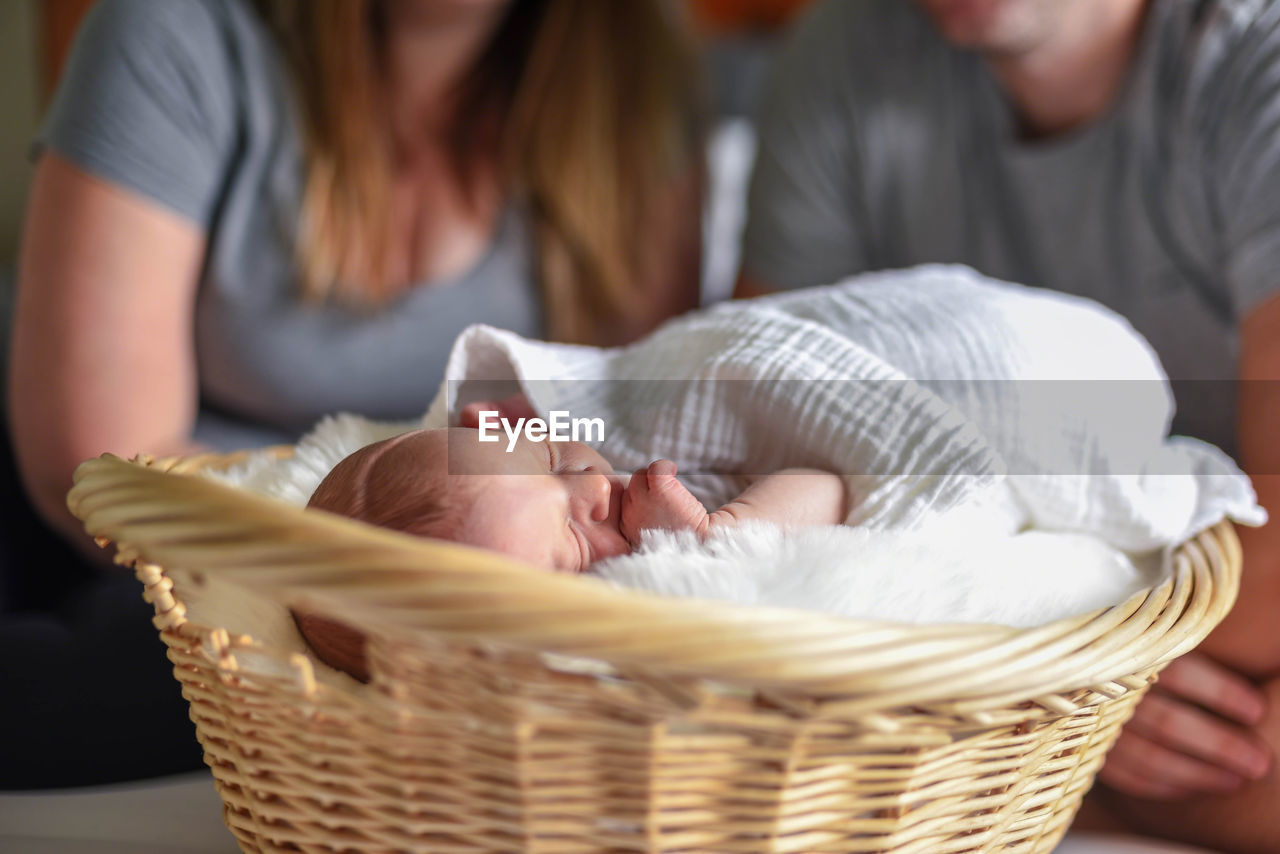 Family sitting on bed at home