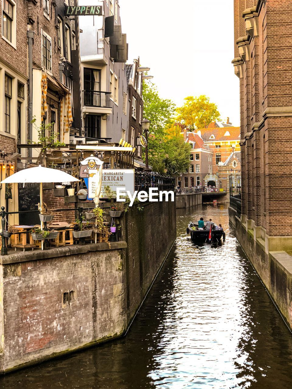 VIEW OF CANAL AMIDST BUILDINGS IN CITY