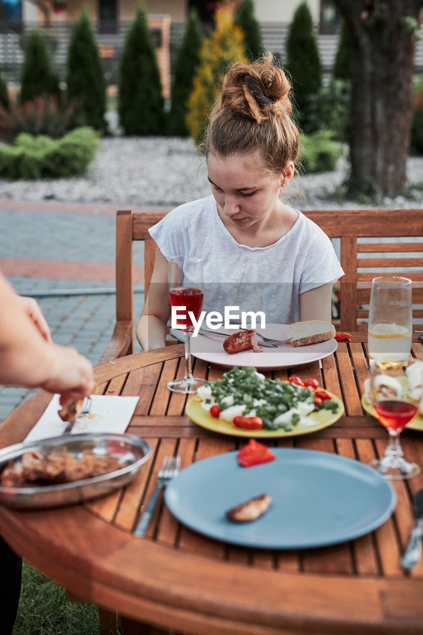 Girl sitting at restaurant outdoors