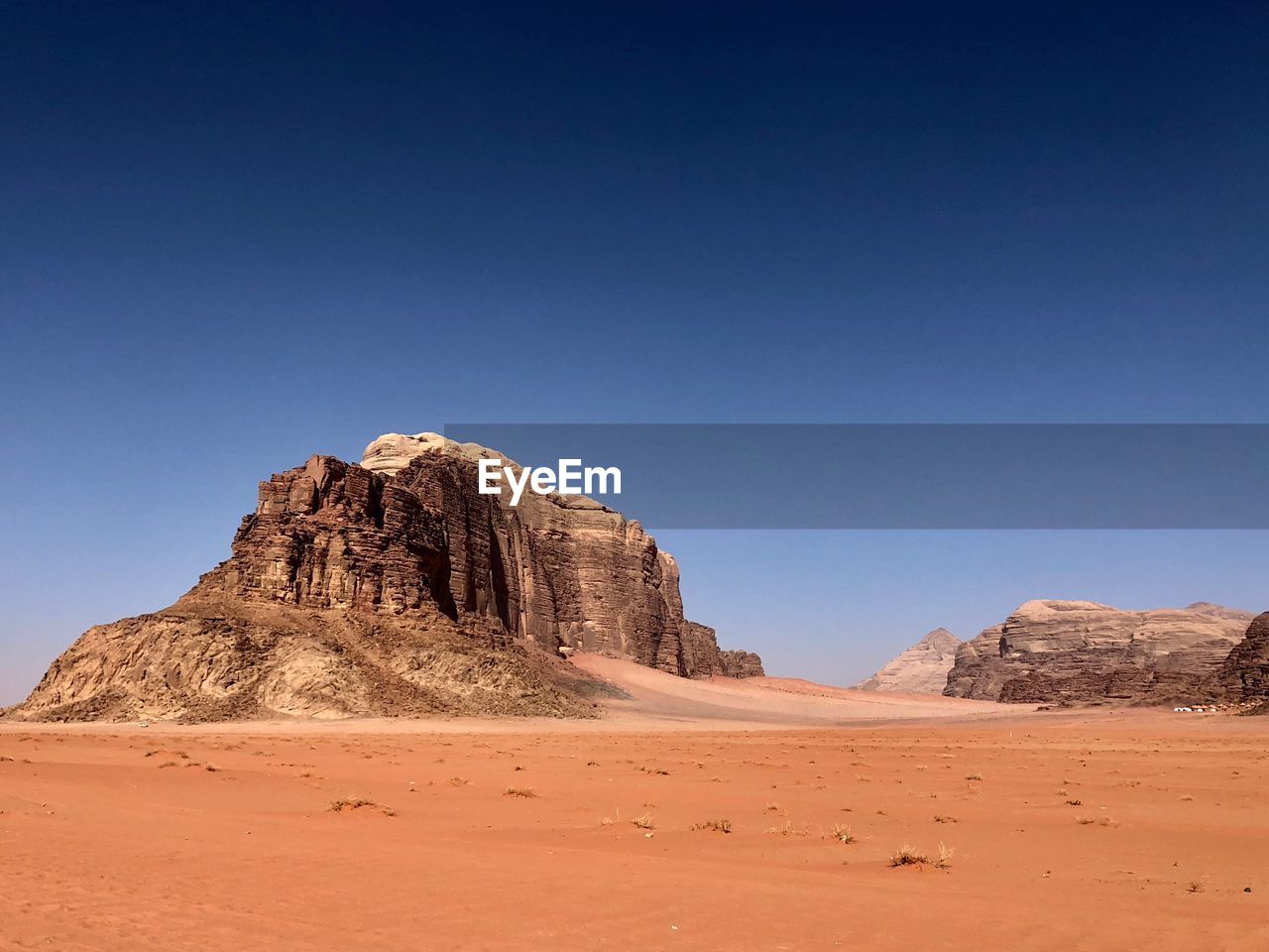 Rock formations in desert against clear blue sky