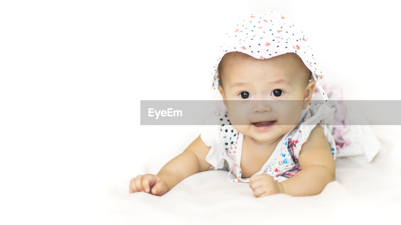 Portrait of baby girl against white background