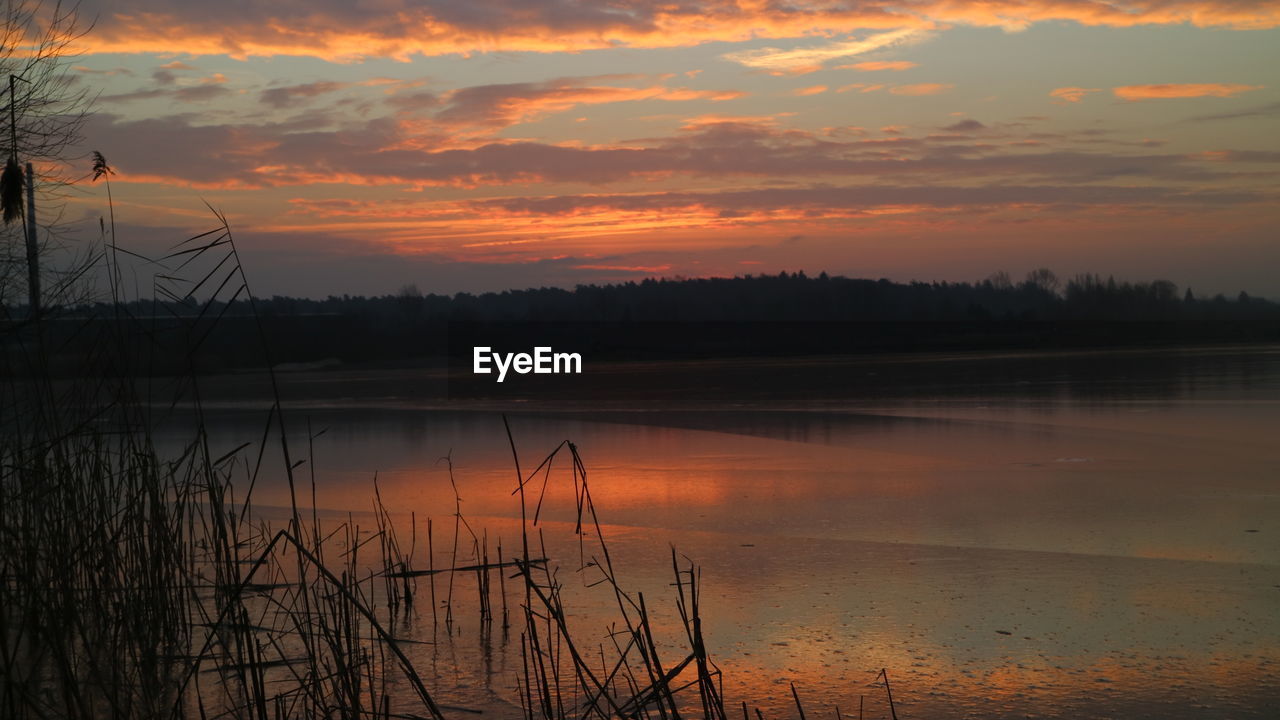 DRAMATIC SKY OVER LAKE DURING SUNSET