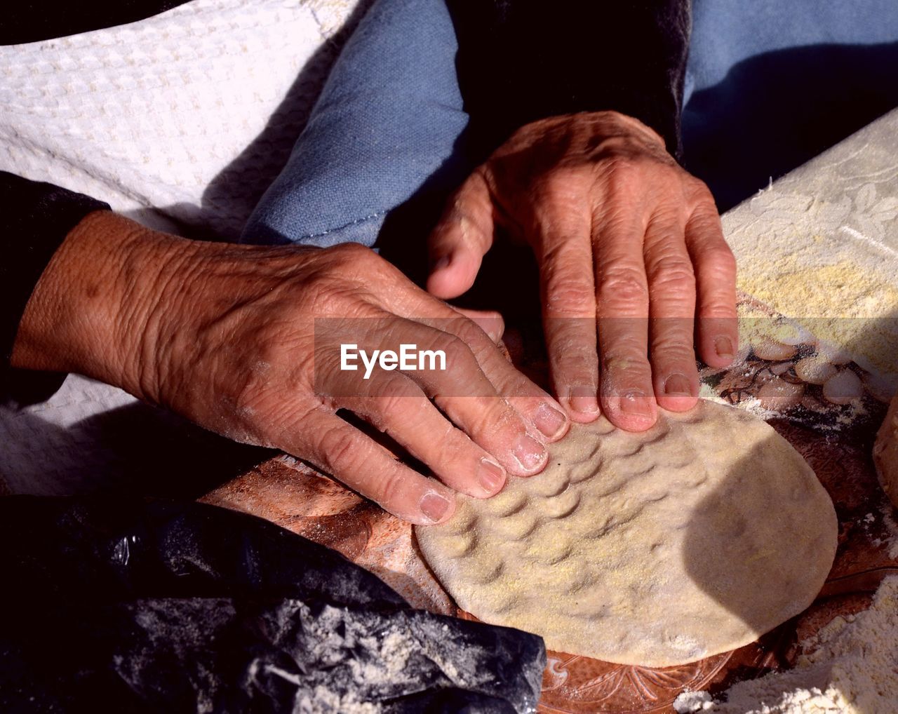 Cropped image of person making pita bread