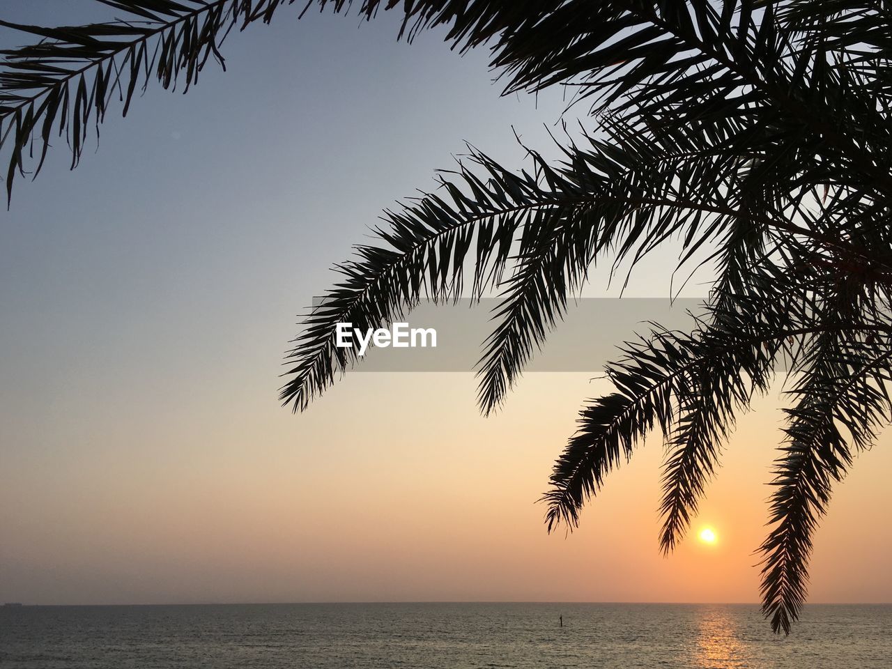 Scenic view of sea against sky at sunset