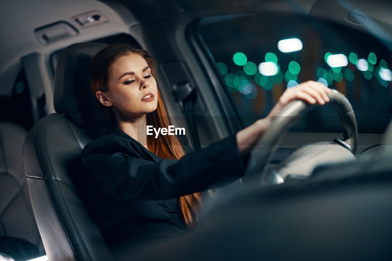 Frustrated young woman driving car