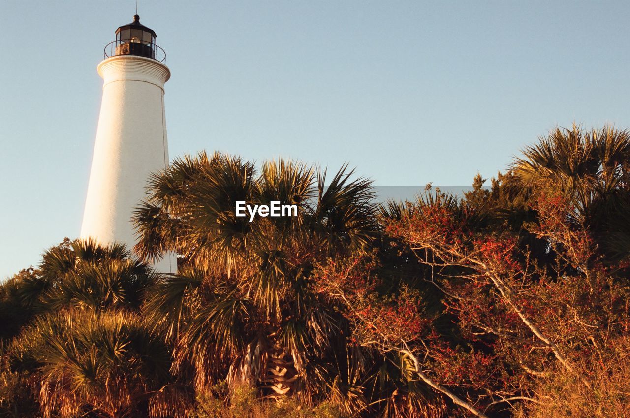 low angle view of lighthouse on field against clear sky