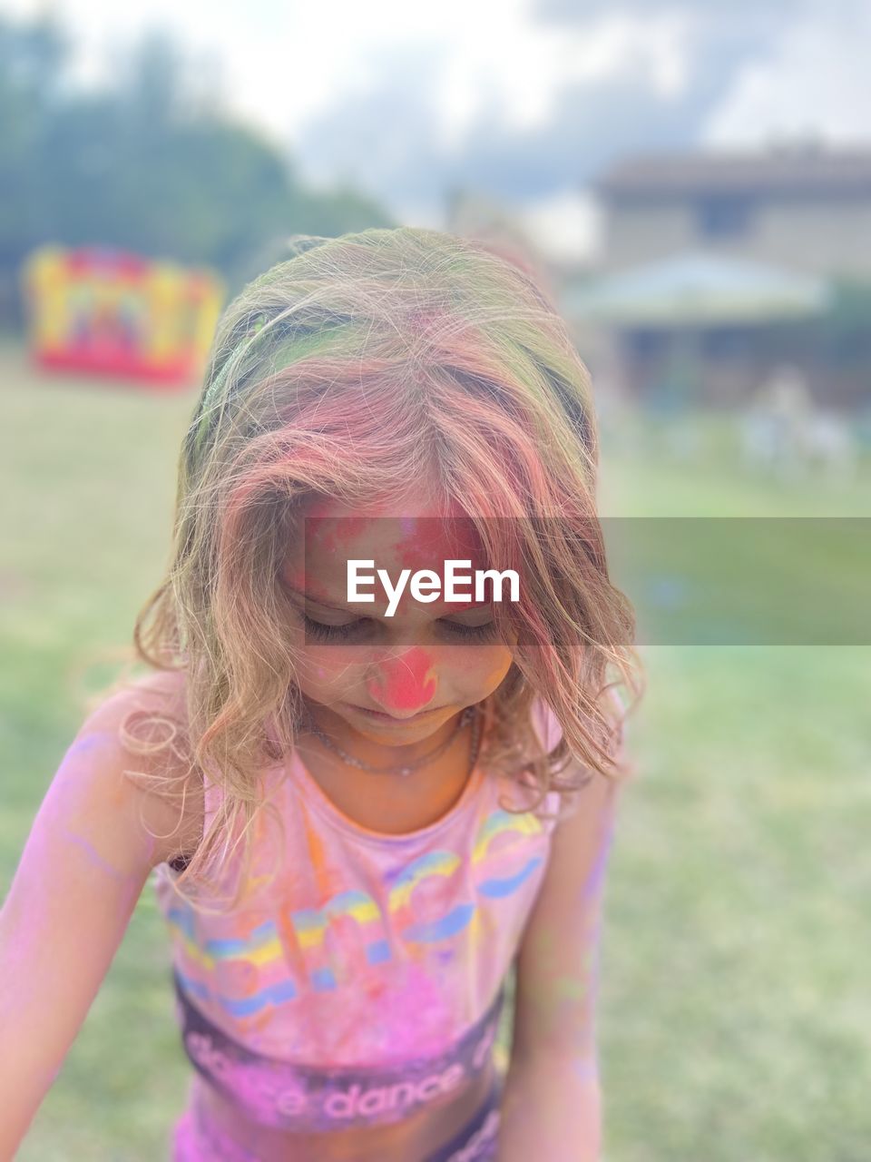 childhood, child, one person, pink, women, front view, hairstyle, day, focus on foreground, female, fun, emotion, portrait, human face, person, teenager, innocence, nature, clothing, standing, waist up, smiling, outdoors, long hair, happiness, leisure activity, casual clothing, human hair, summer, human head, multi colored, looking down, skin, grass, lifestyles, enjoyment, facial expression, looking, blond hair