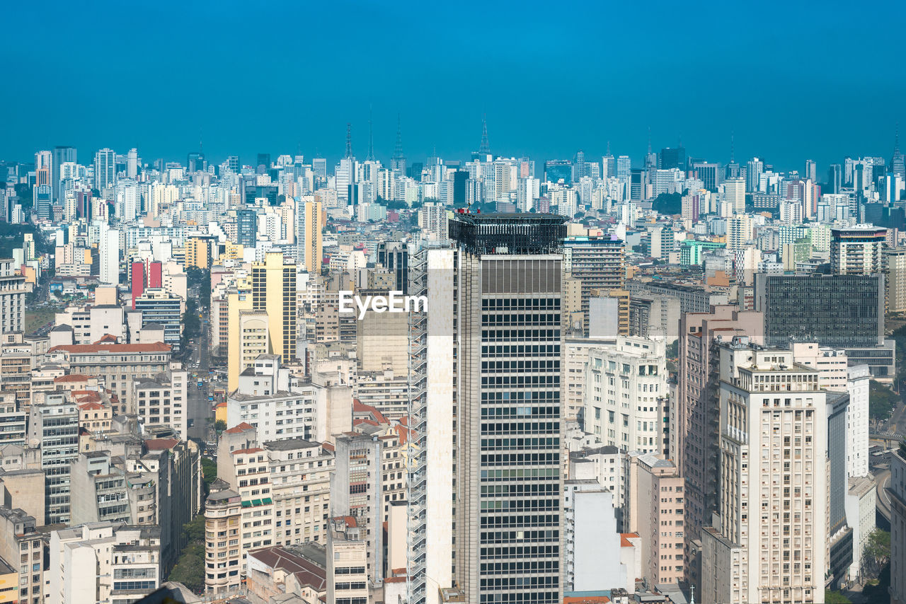 Aerial view of modern buildings in city against sky