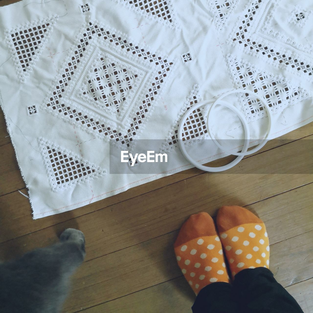 Low section of woman standing on hardwood floor