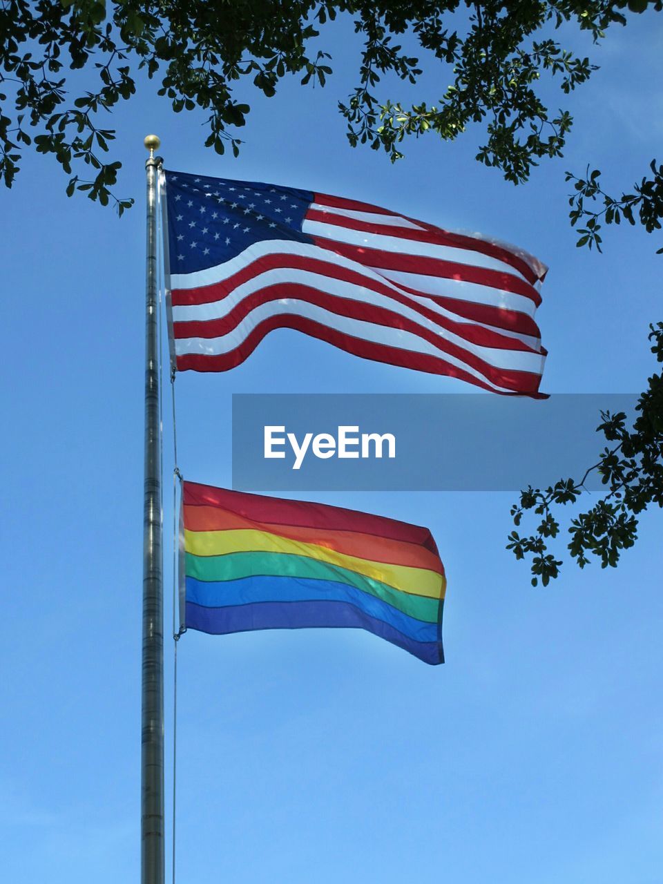 Low angle view of flag against clear blue sky