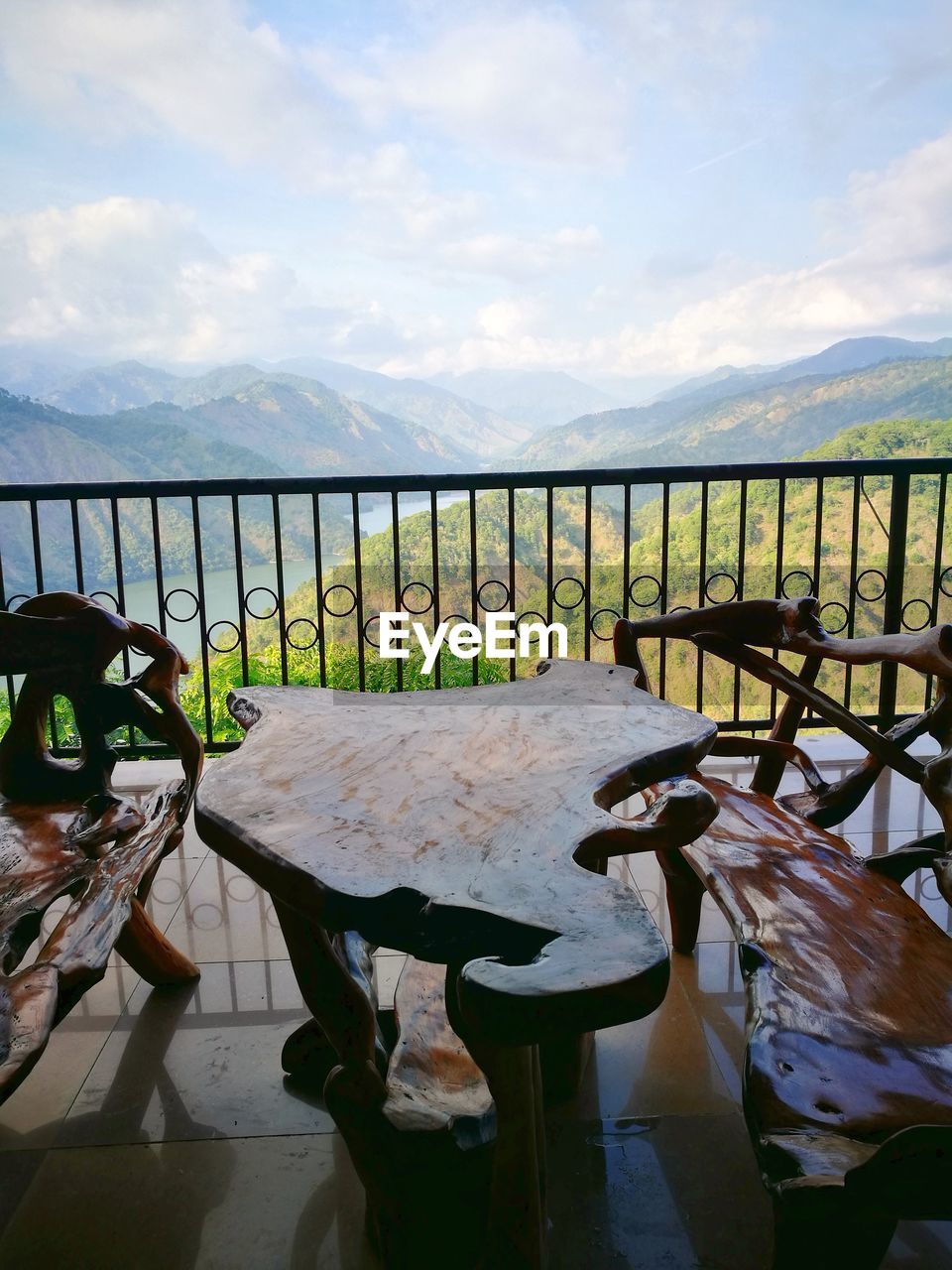 CHAIRS AND TABLE AGAINST SEA