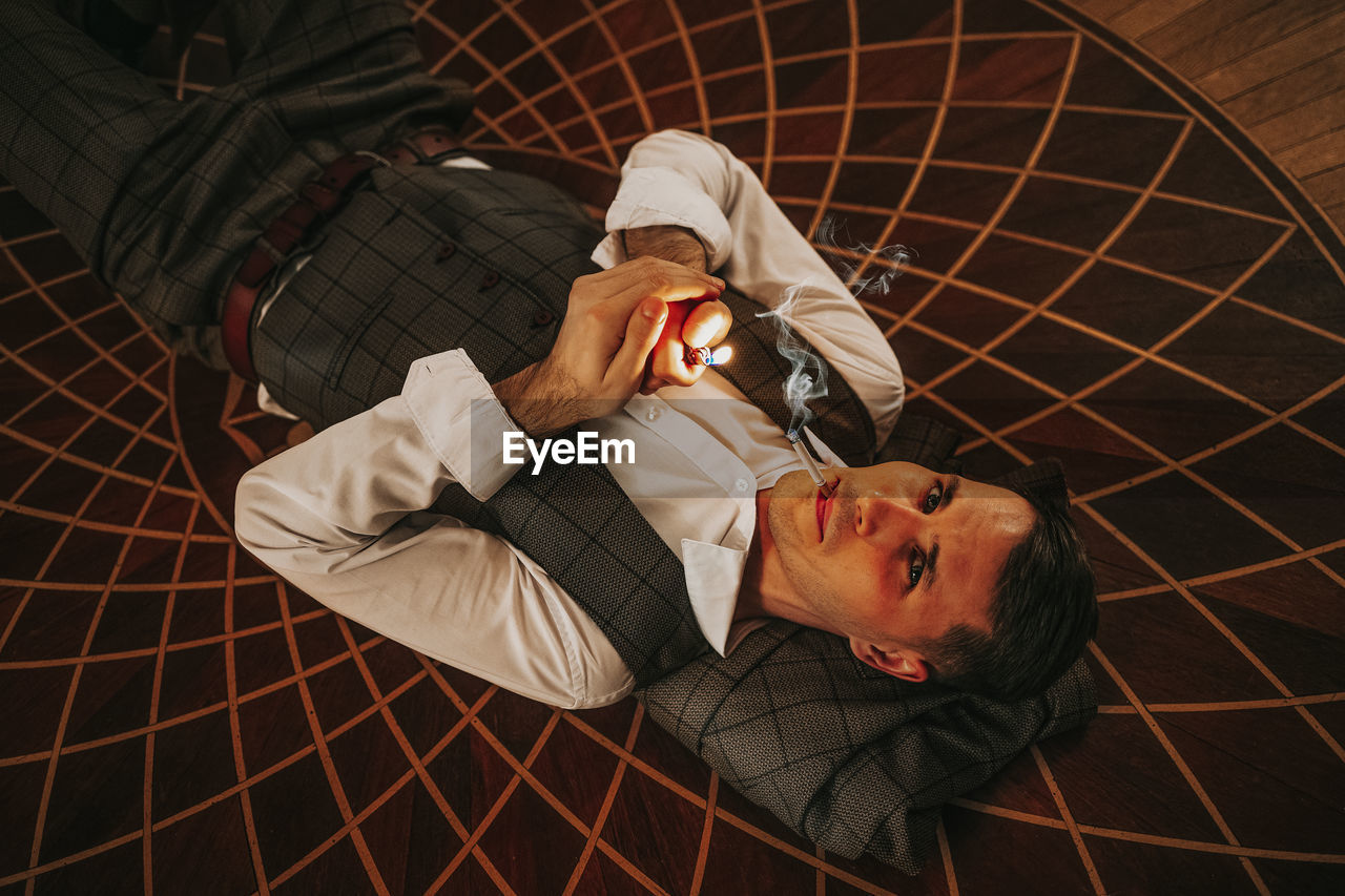 High angle view of man lying on floor