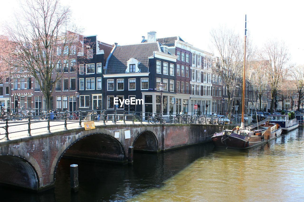 VIEW OF CANAL WITH BUILDINGS IN BACKGROUND