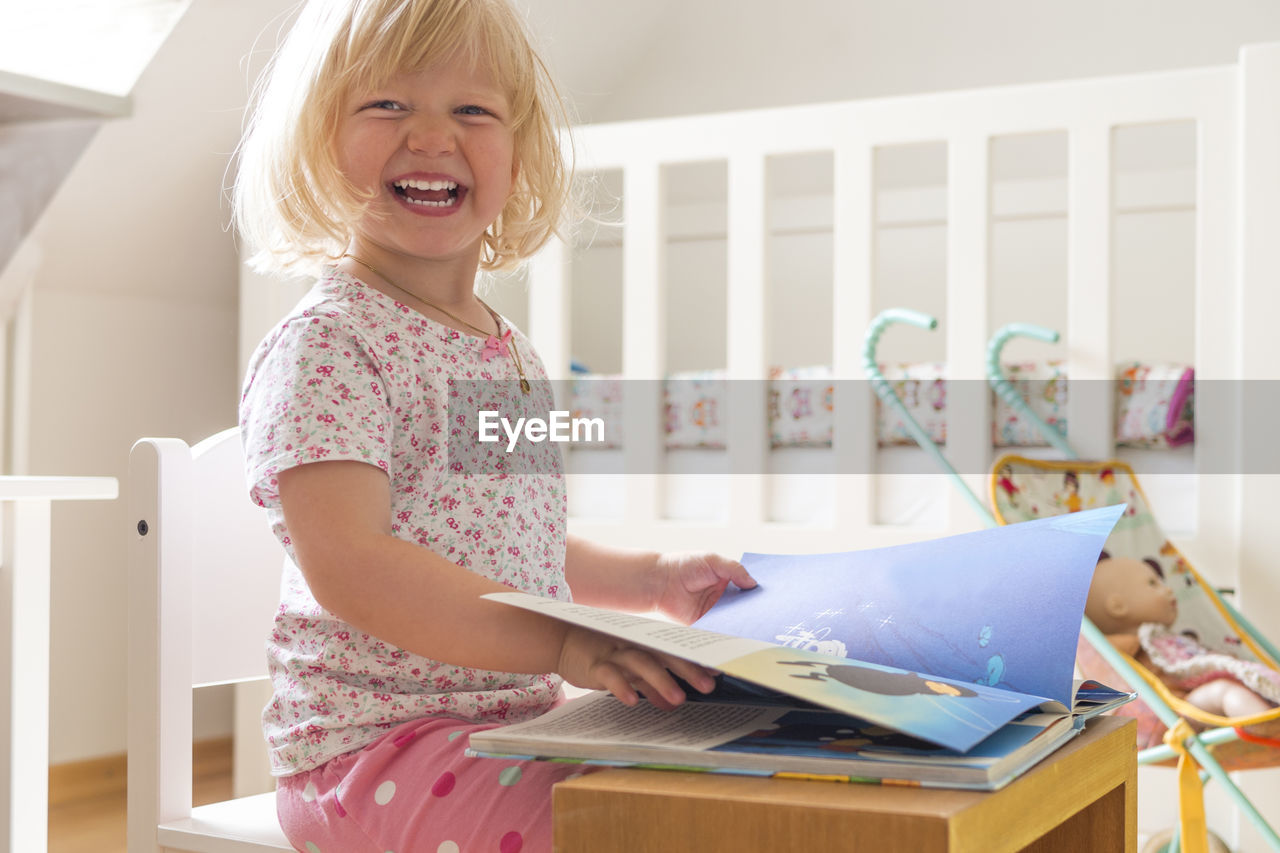 Portrait of happy girl with book