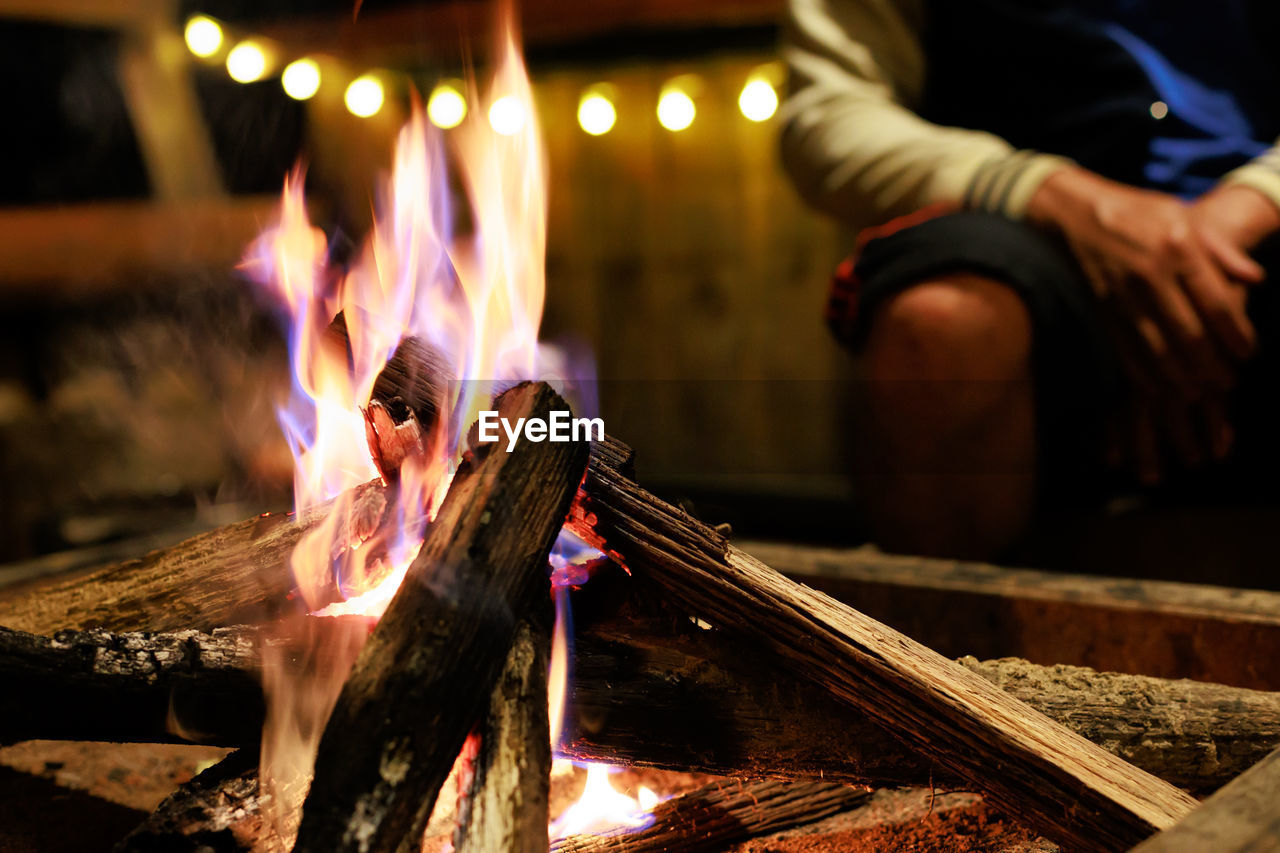 heat, burning, fire, flame, one person, adult, motion, wood, men, hand, occupation, nature, night, food and drink, food, blurred motion, barbecue, campfire, glowing, indoors