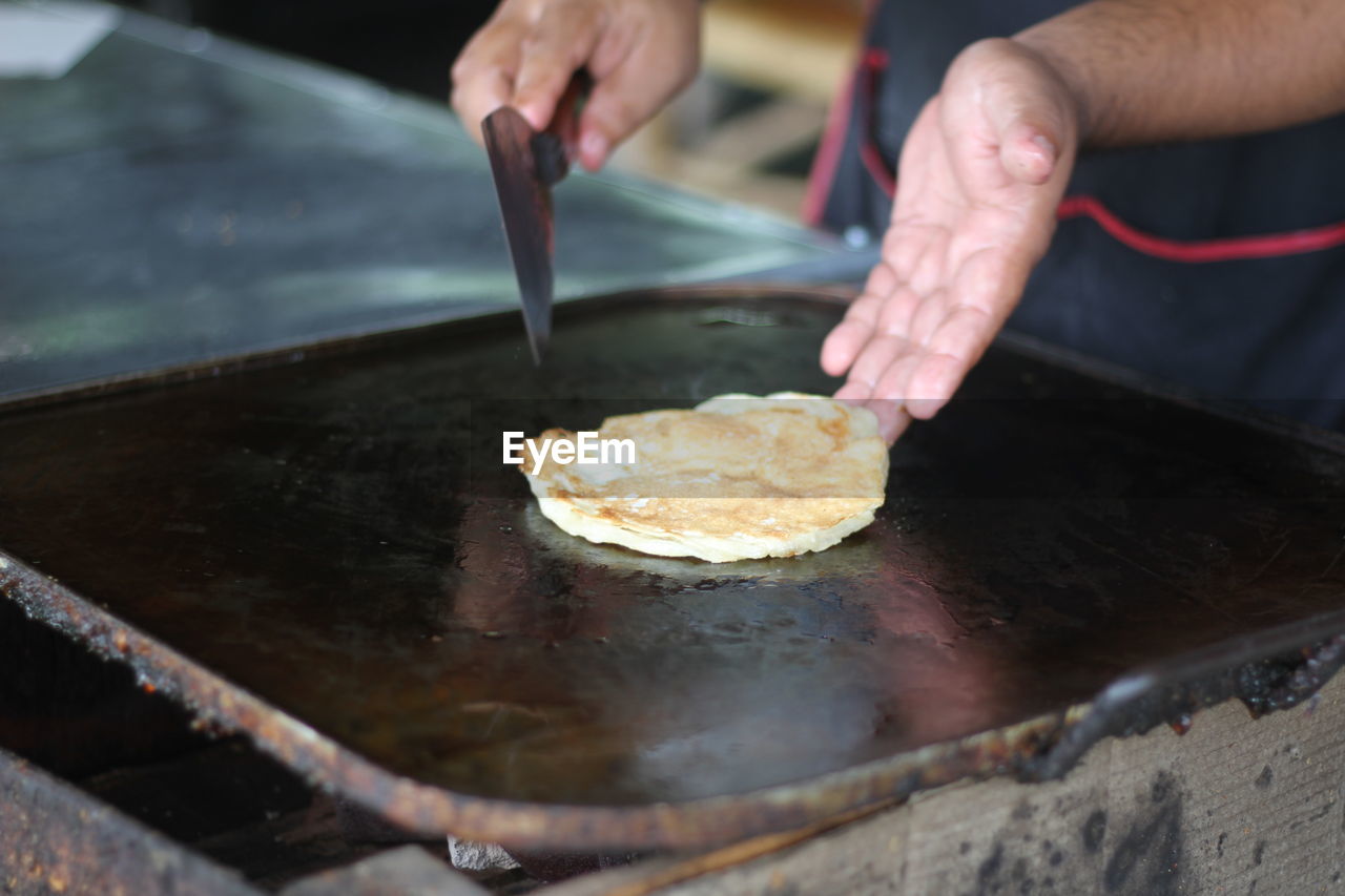 Midsection of man preparing food