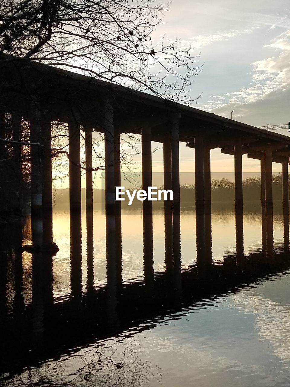 SILHOUETTE OF BRIDGE OVER RIVER AGAINST SKY