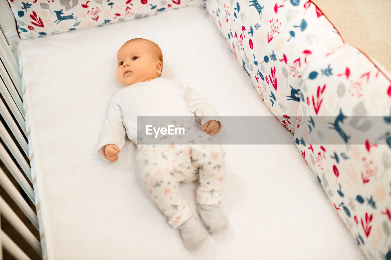 High angle view of girl sleeping on bed