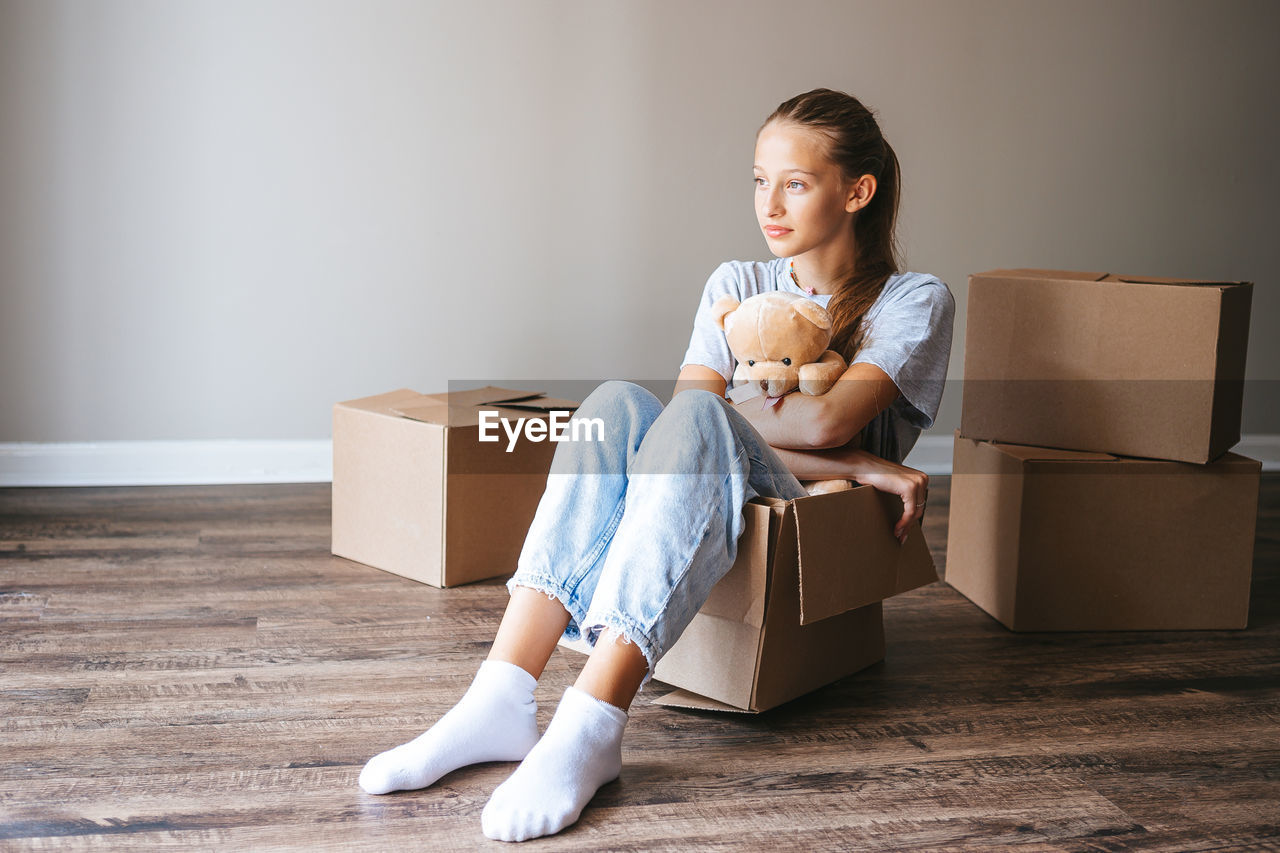 portrait of young woman sitting on sofa