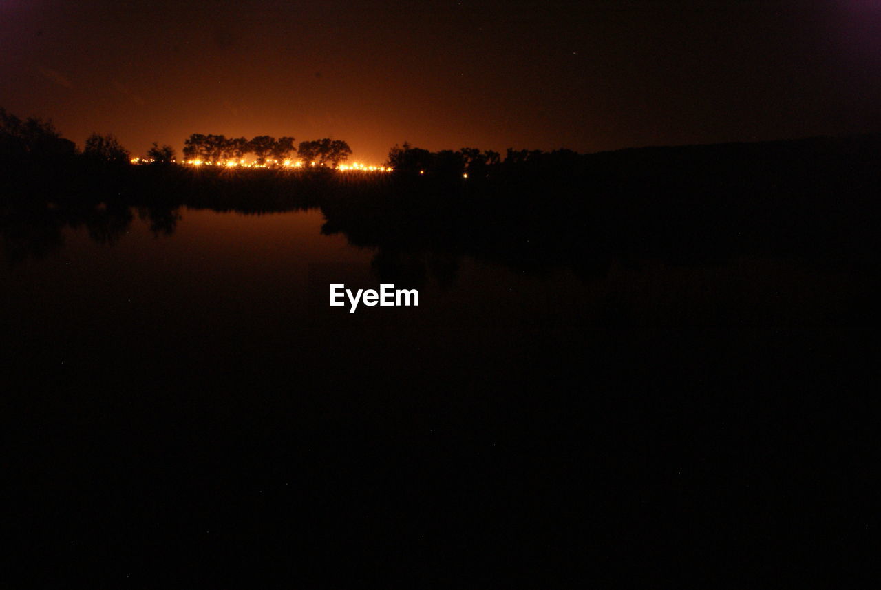 Scenic view of lake at night