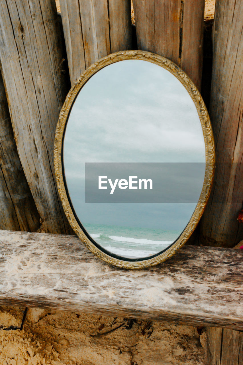 Golden antigue mirror reflecting the sea