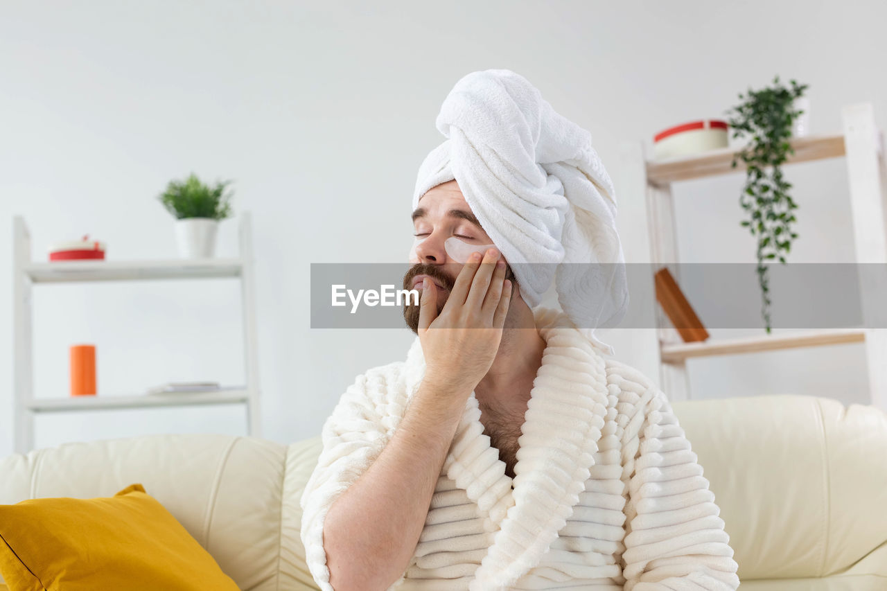 Young woman sitting on sofa at home