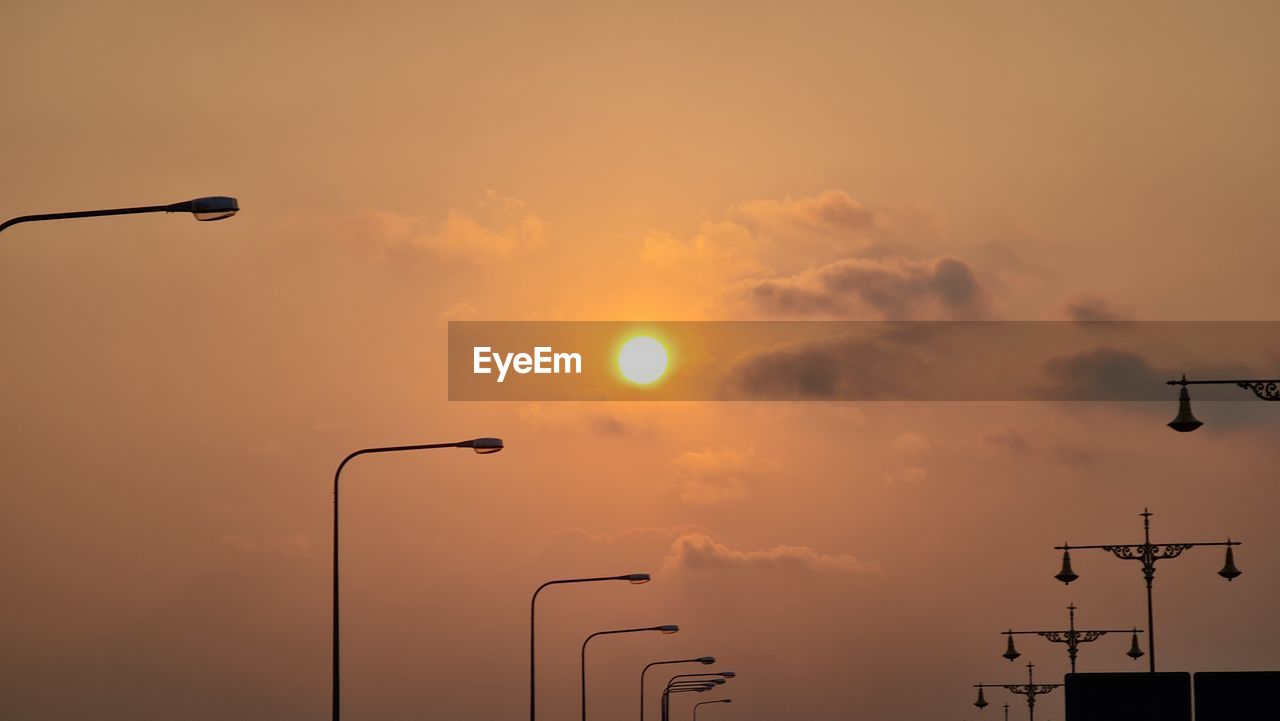 Low angle view of street light against sky during sunset