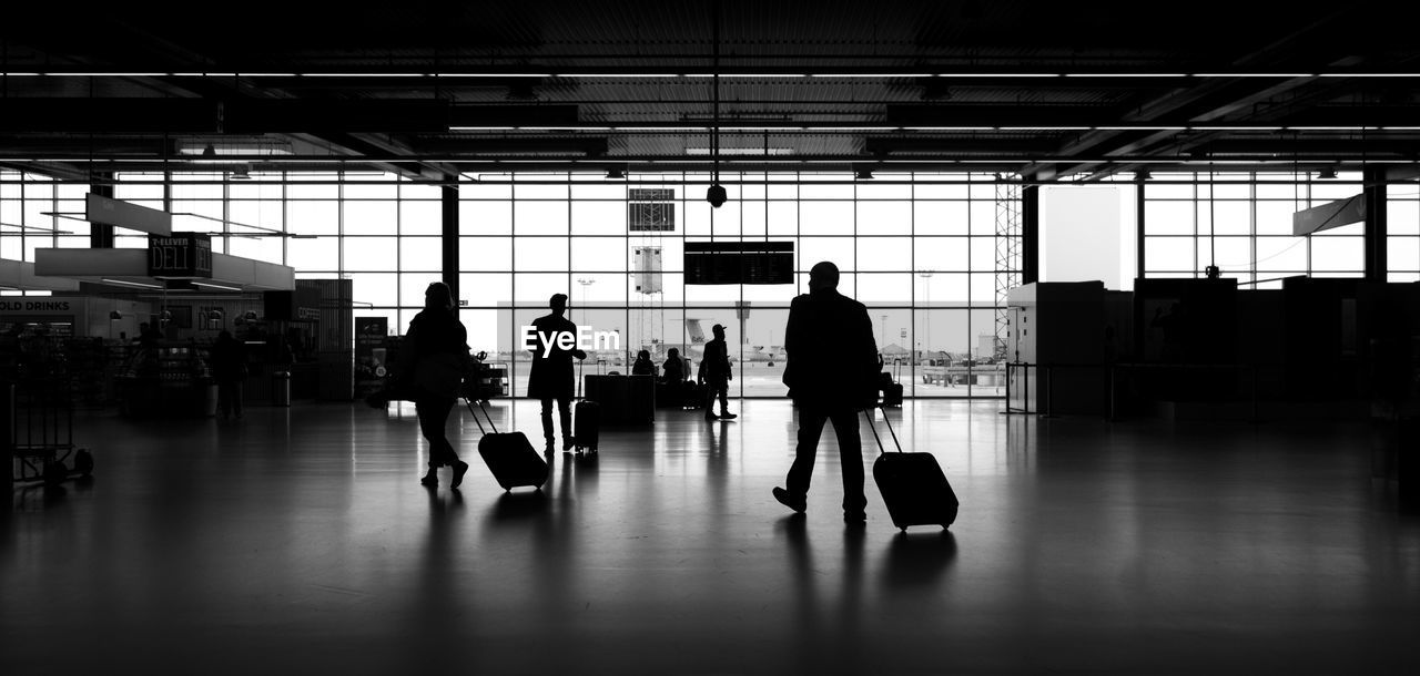 SILHOUETTE PEOPLE WALKING ON AIRPORT