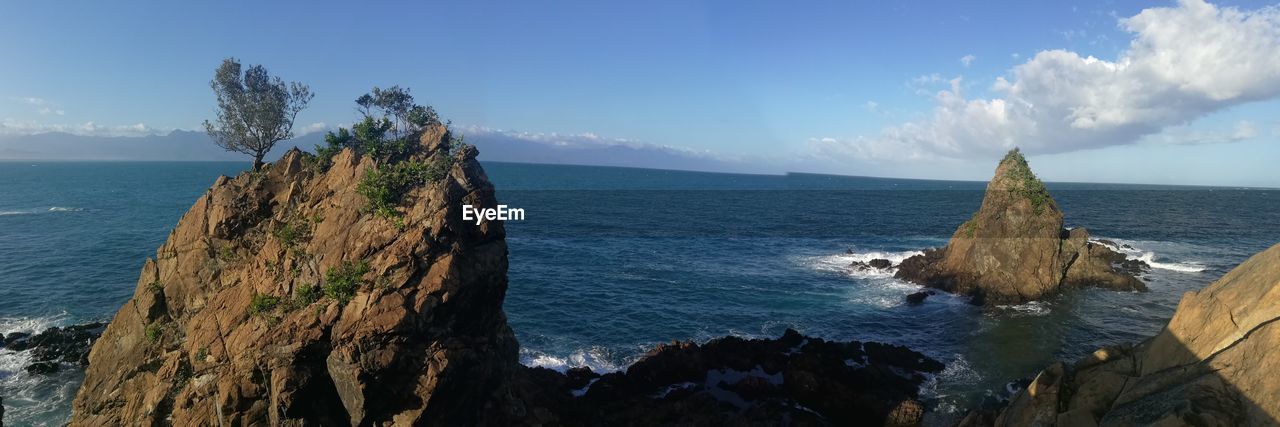 Panoramic view of sea against blue sky