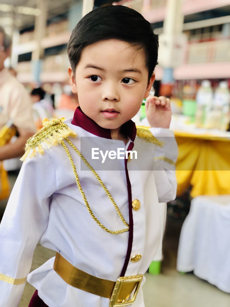 PORTRAIT OF CUTE BOY STANDING AT STORE