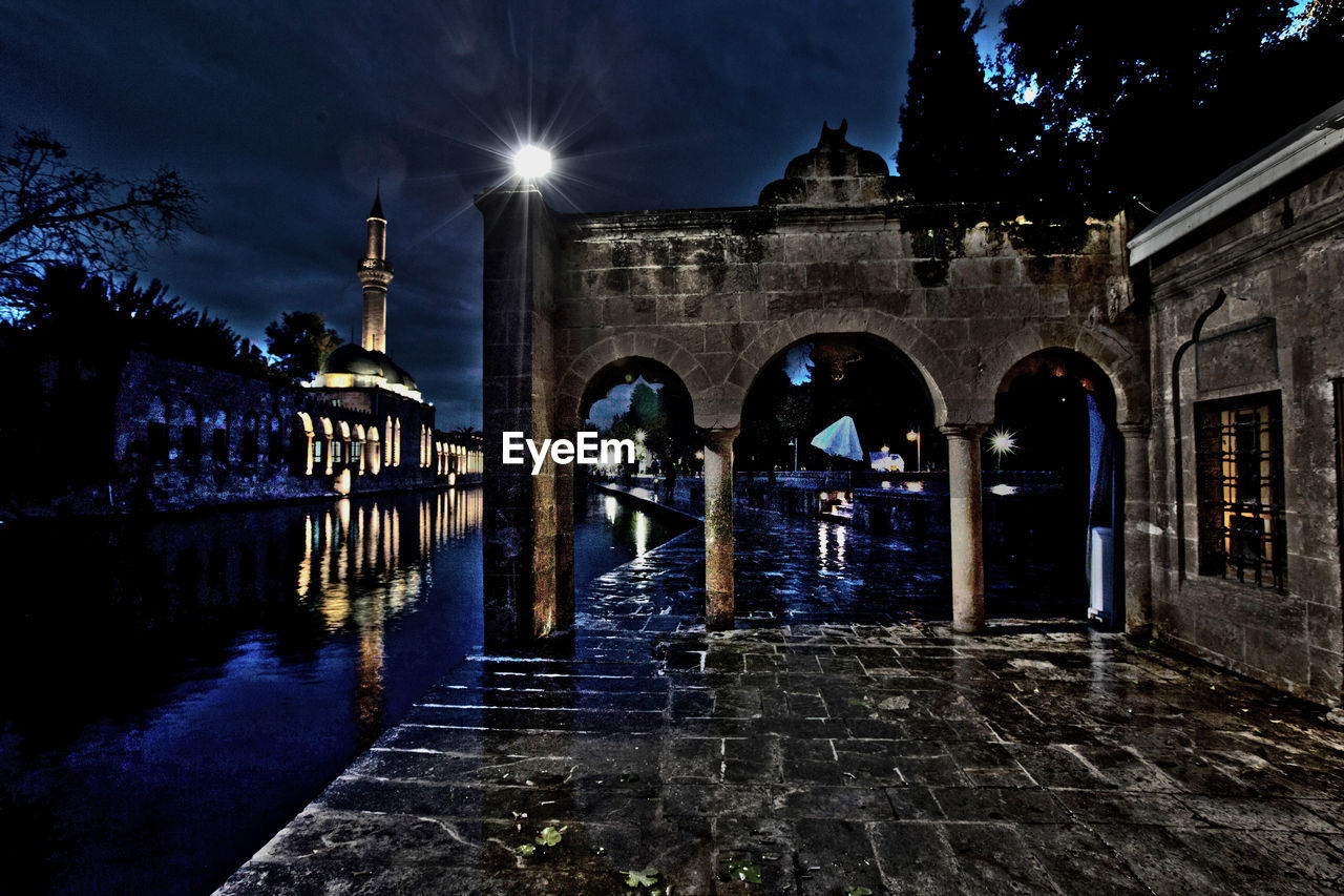 VIEW OF ILLUMINATED BUILDING BY CANAL