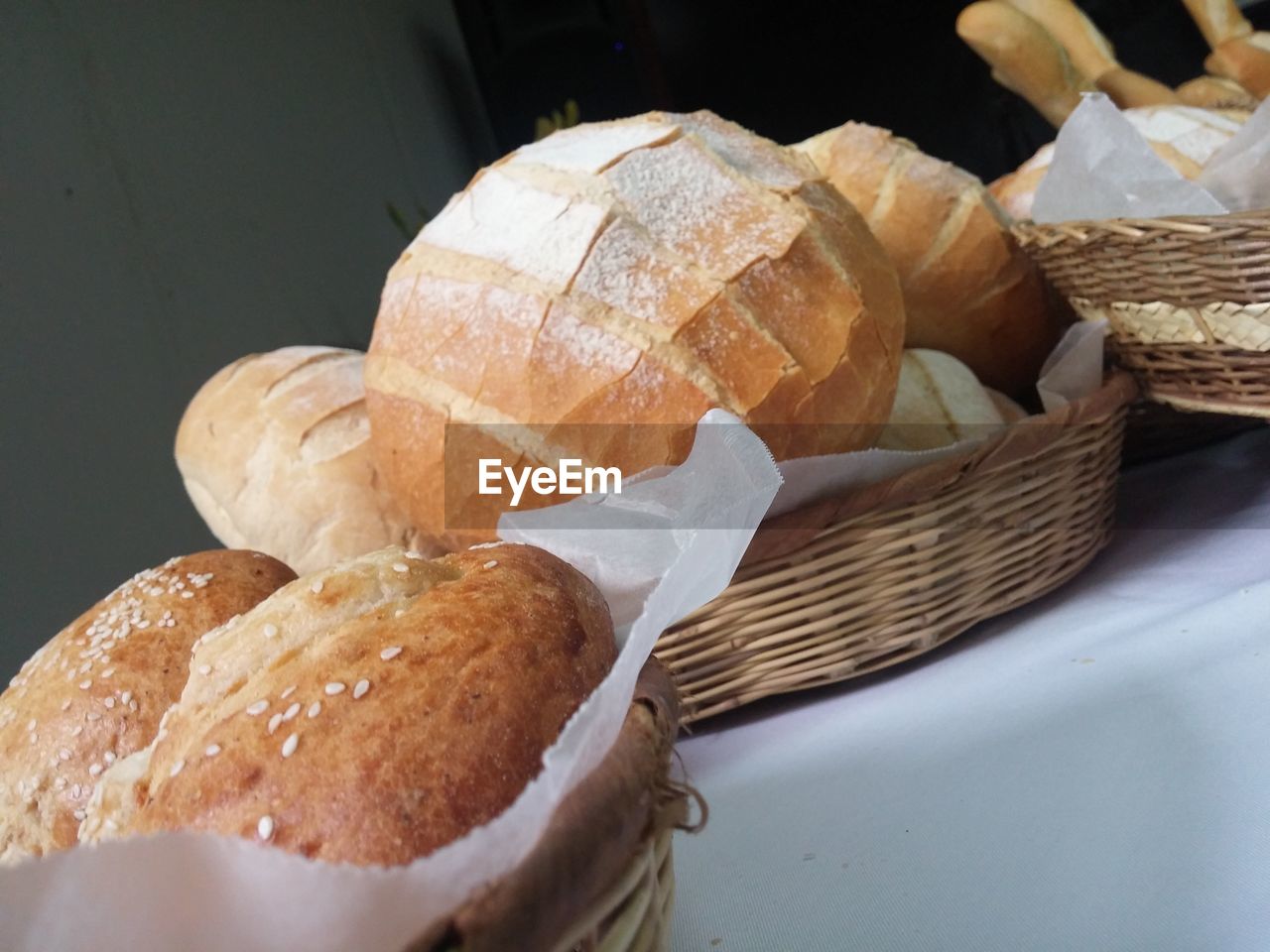 Close-up of homemade breads in wicker basket on table