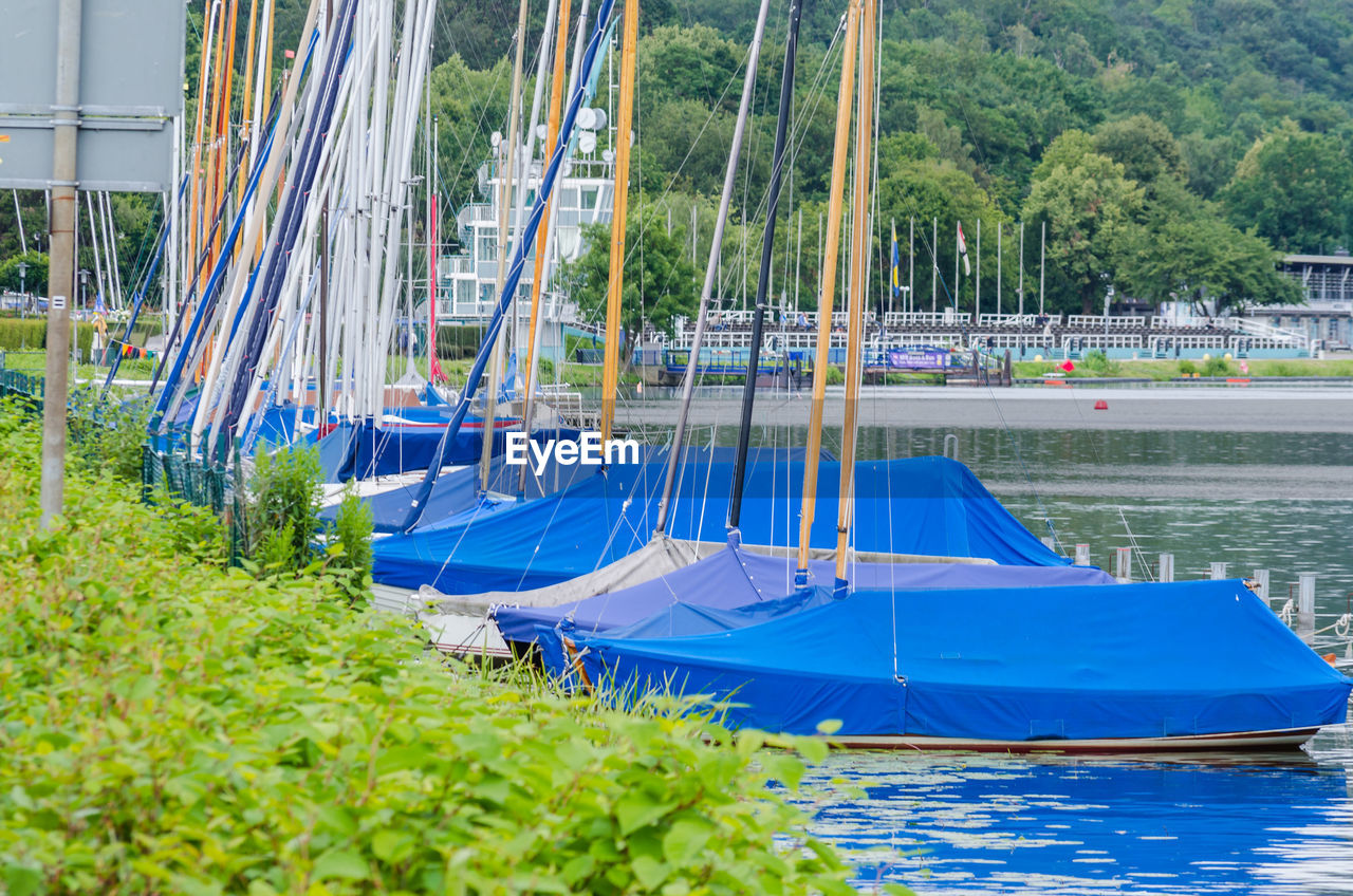 SAILBOAT MOORED IN SEA