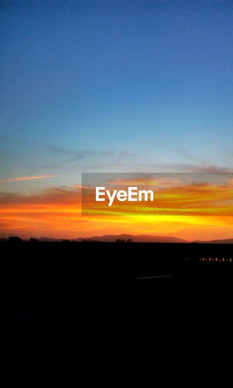 SCENIC VIEW OF SKY OVER SILHOUETTE TREES AGAINST SUNSET