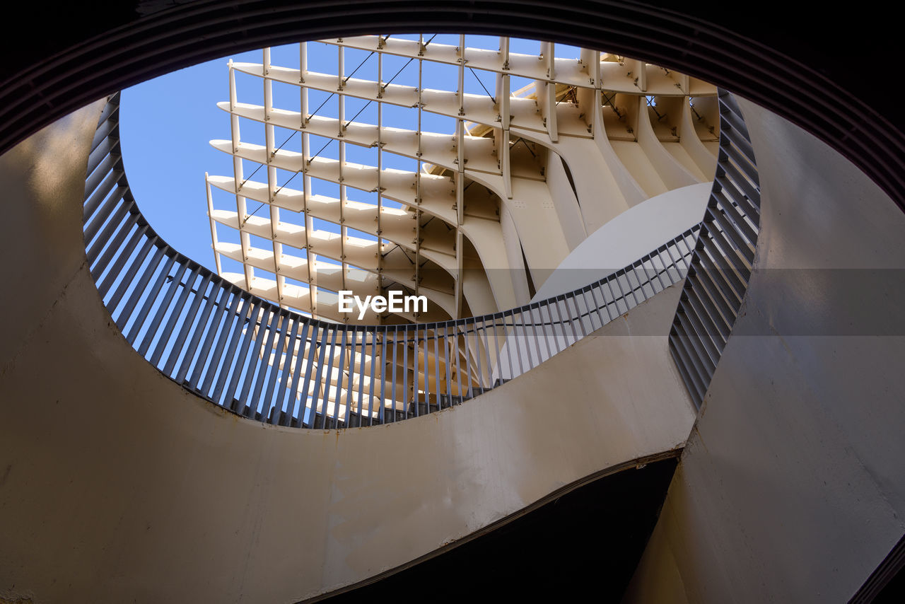 DIRECTLY BELOW SHOT OF SPIRAL STAIRCASE IN BUILDING