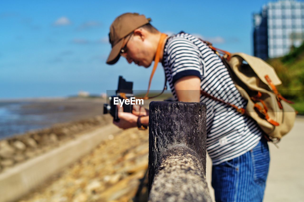 Side view of man working at beach