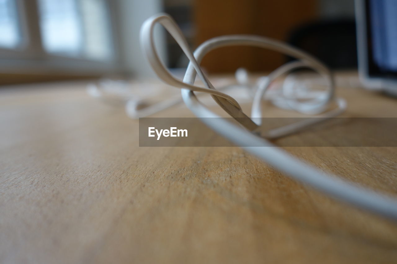 CLOSE-UP OF EYEGLASSES AND TABLE