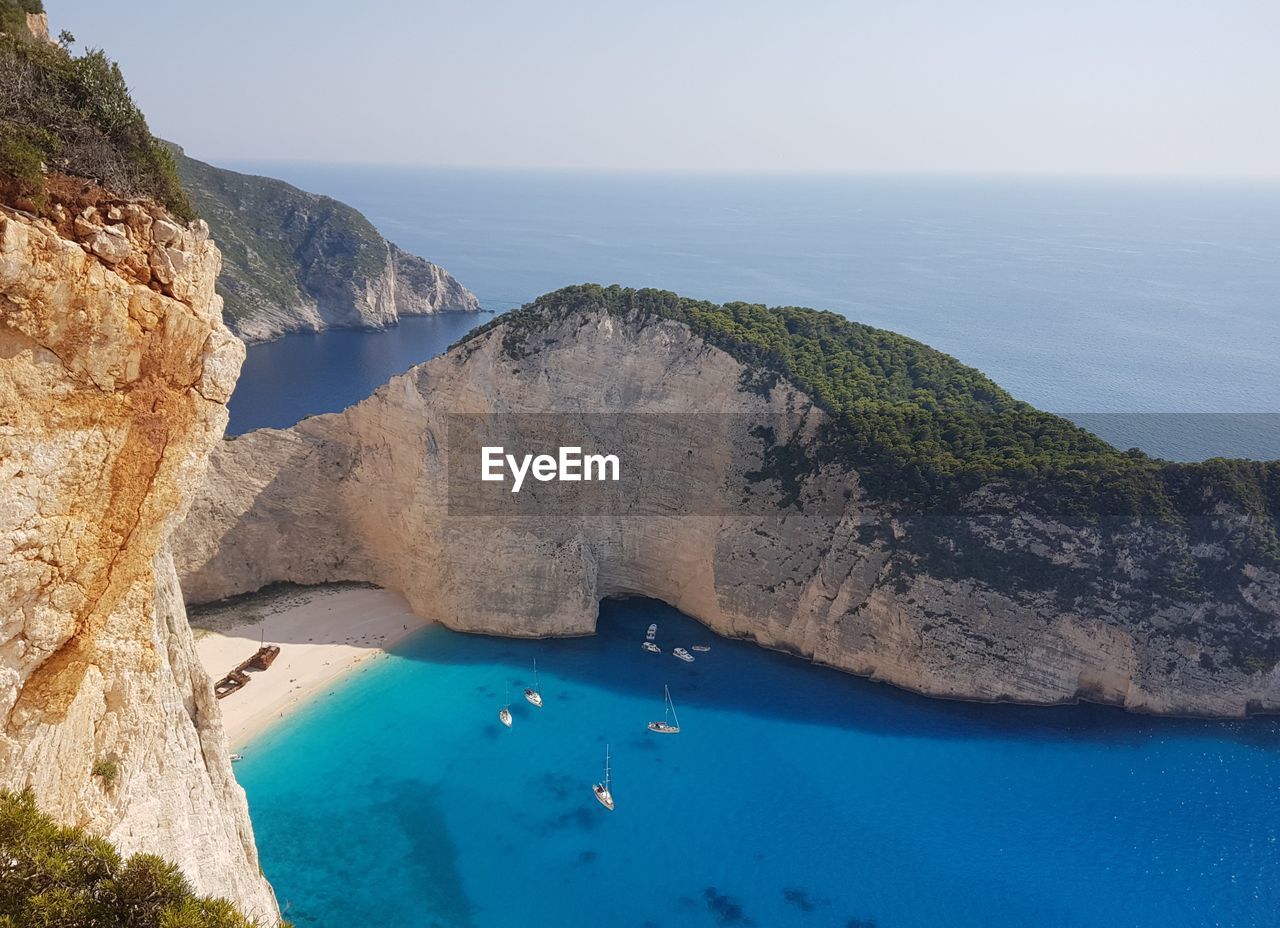 Scenic view of sea and mountains against sky