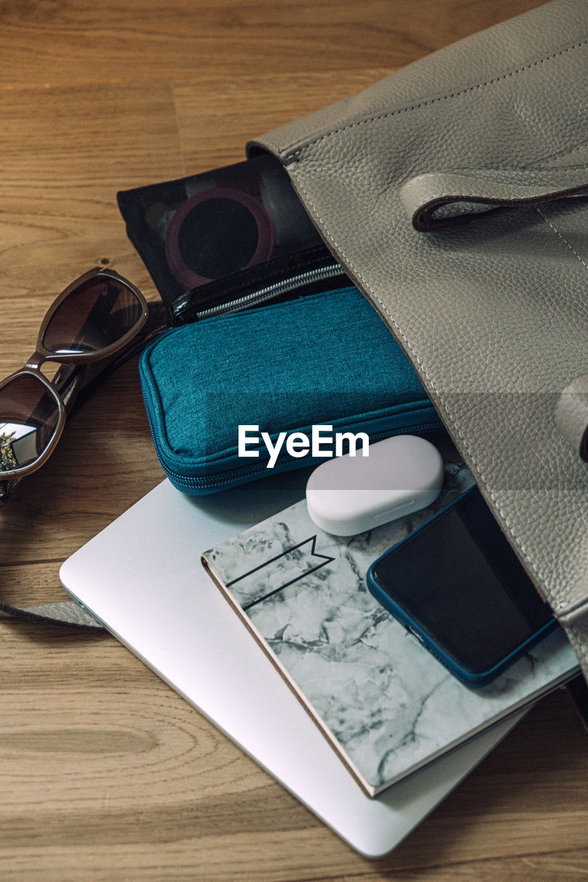 high angle view of personal accessories on wooden table