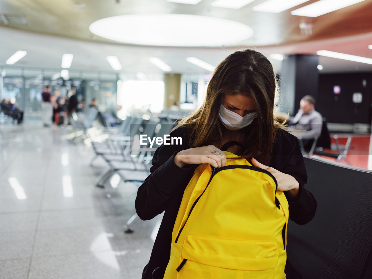 WOMAN STANDING IN AIRPORT