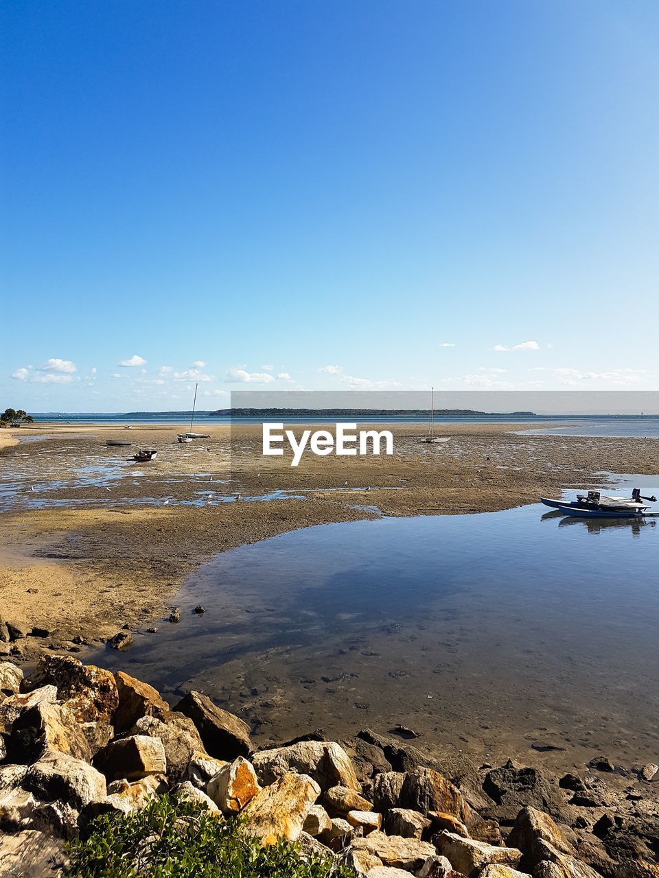 Scenic view of beach against blue sky