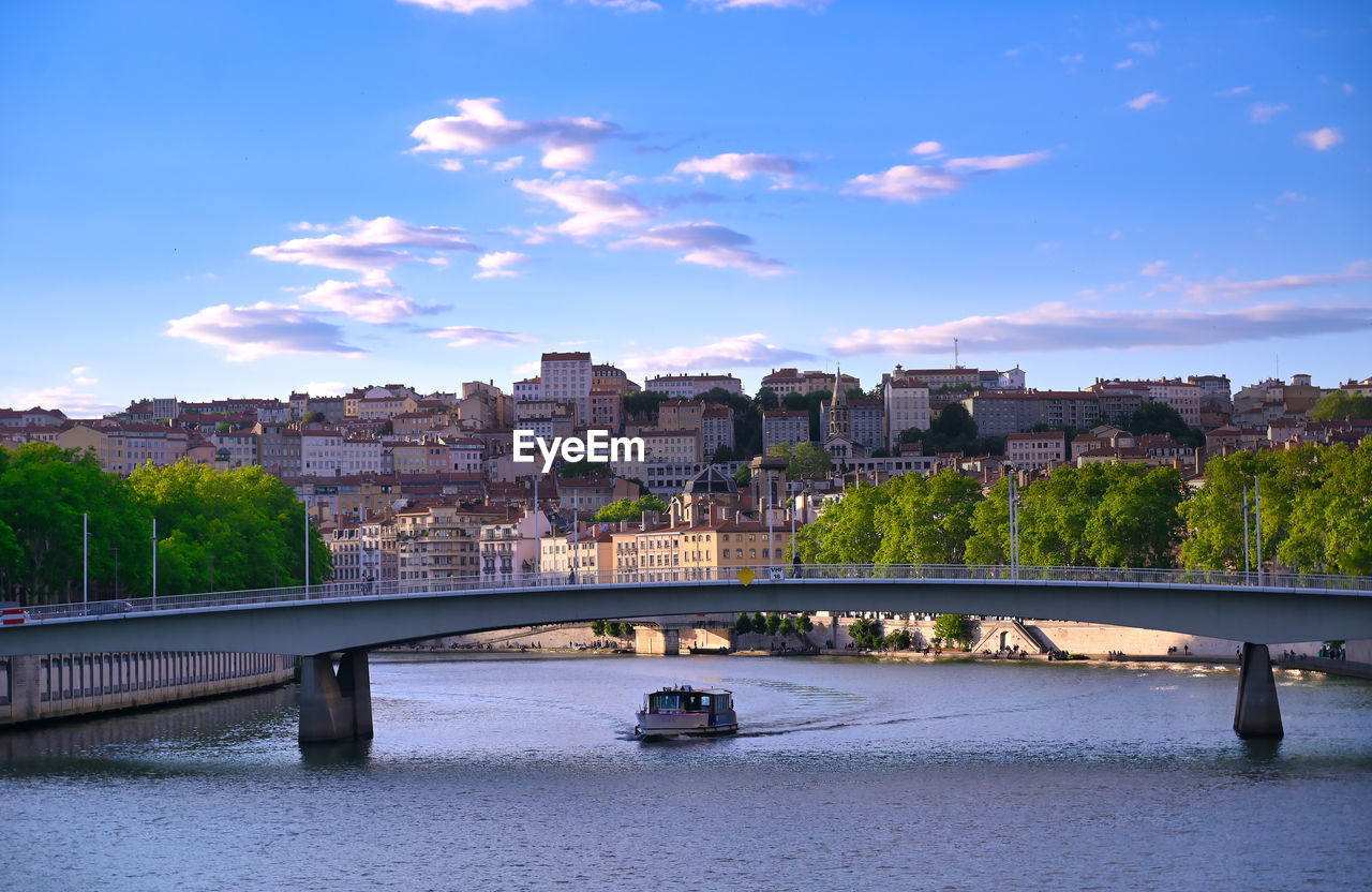 BRIDGE OVER RIVER AGAINST BUILDINGS