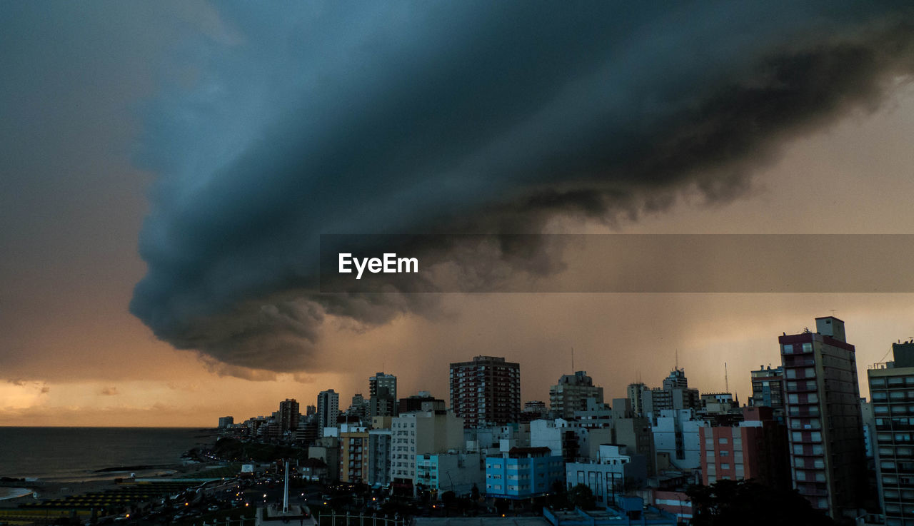 Aerial view of cityscape against dramatic sky