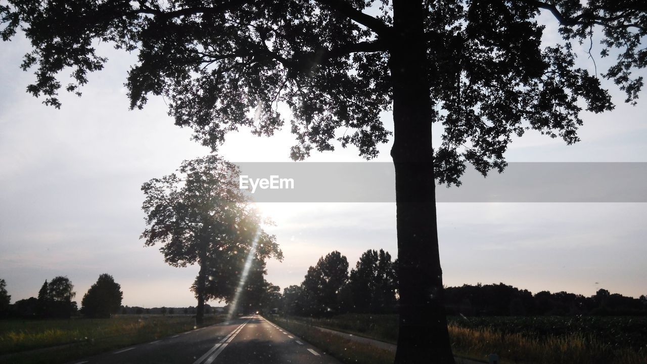 Empty country road against sky