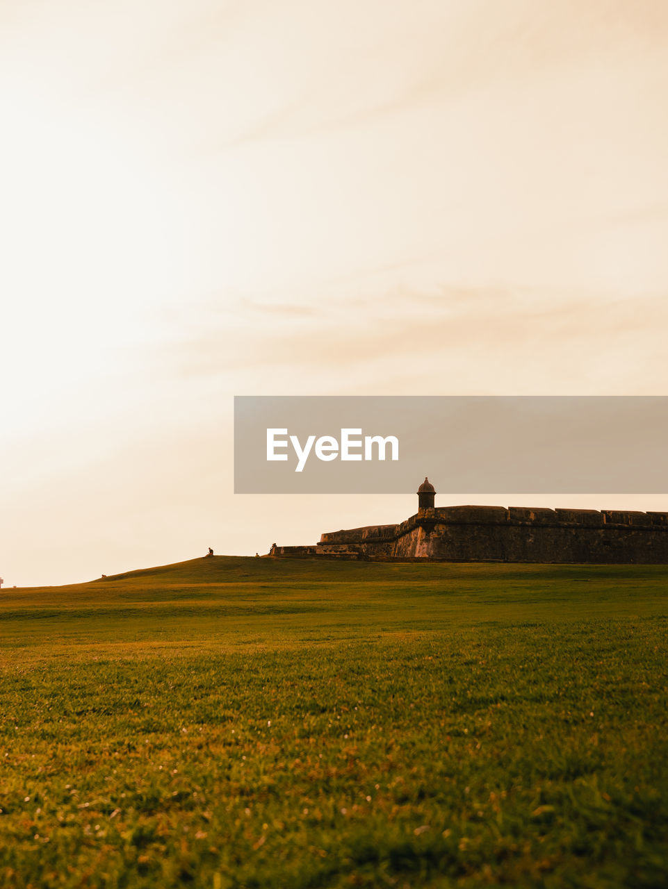 El morro green field in san juan castle san felipe of puerto rico with the golden hour of the sunset