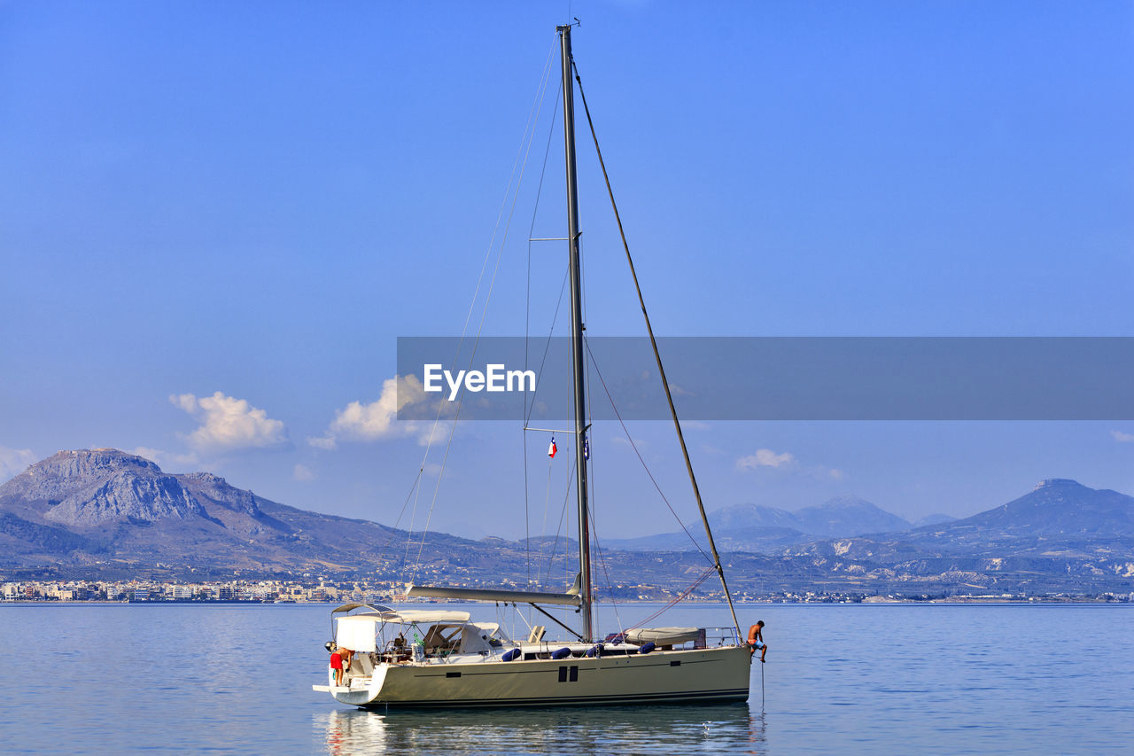 Sailboat sailing on sea against sky