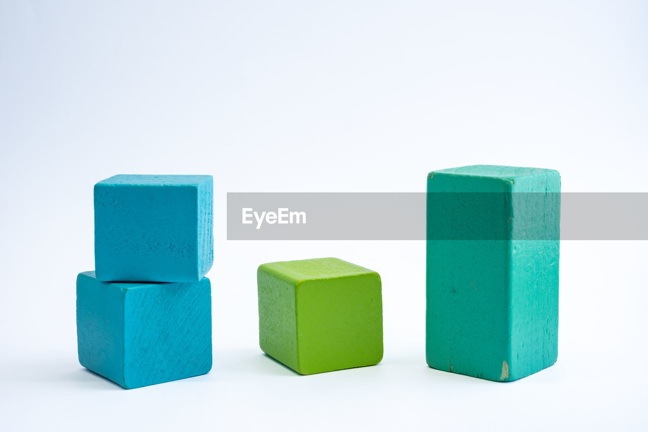 blue, green, toy block, no people, cut out, cube shape, white background, indoors, block shape, studio shot, block, multi colored, group of objects, rectangle, education