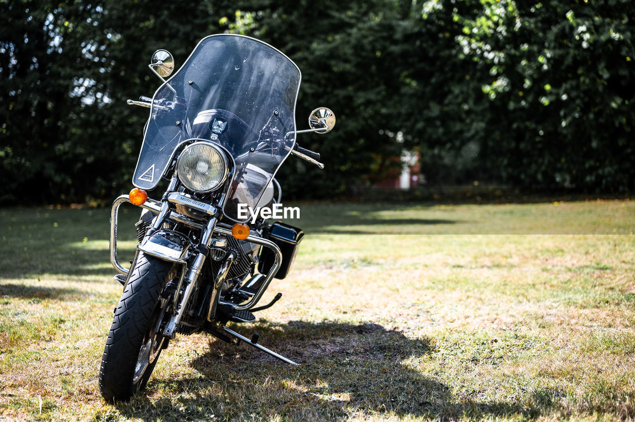 side view of man riding motorcycle on field