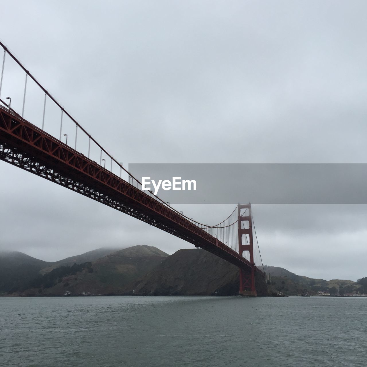 Low angle view of golden gate bridge over bay against sky