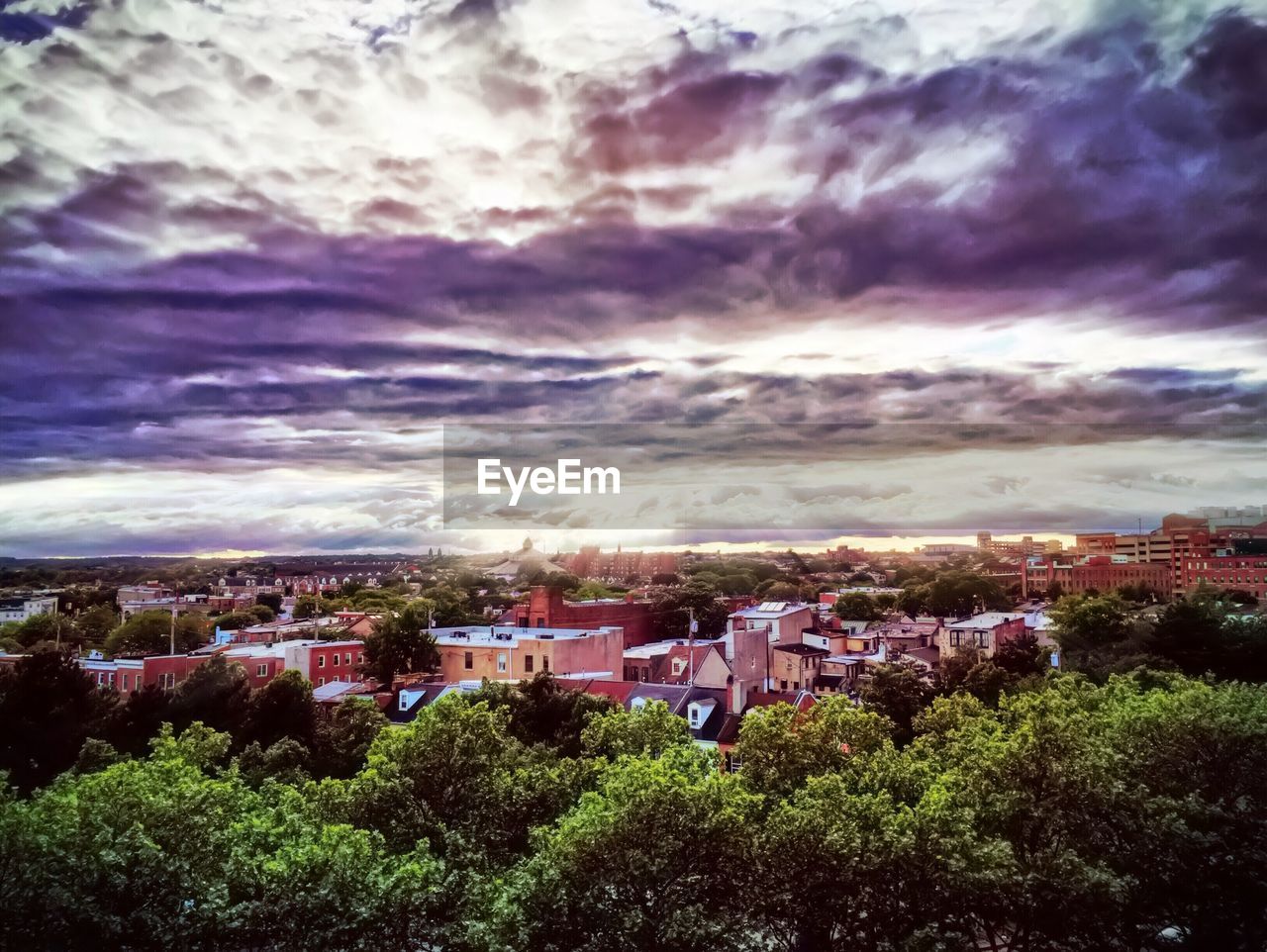 Cityscape against cloudy sky